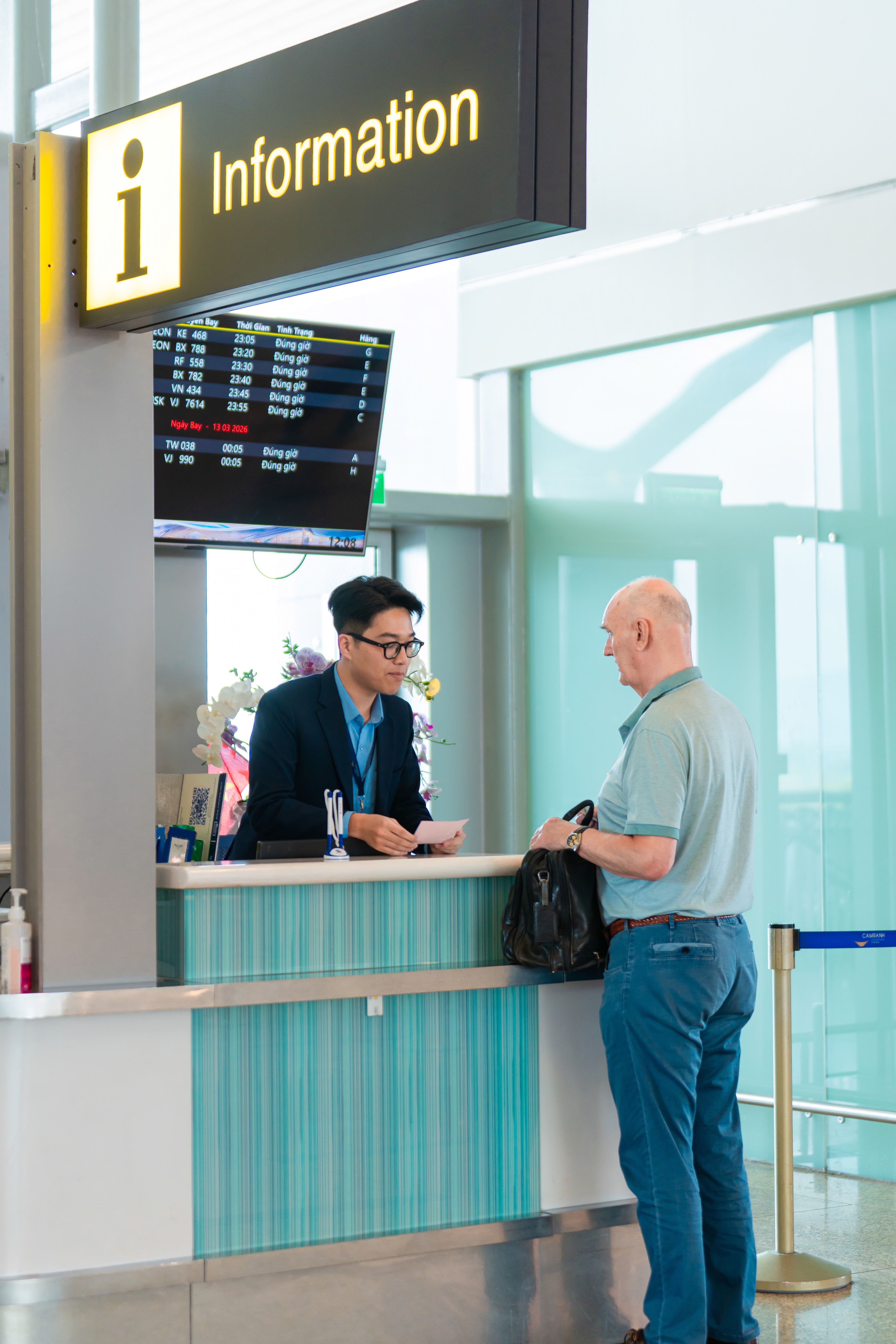 Flight attendant assisting passenger